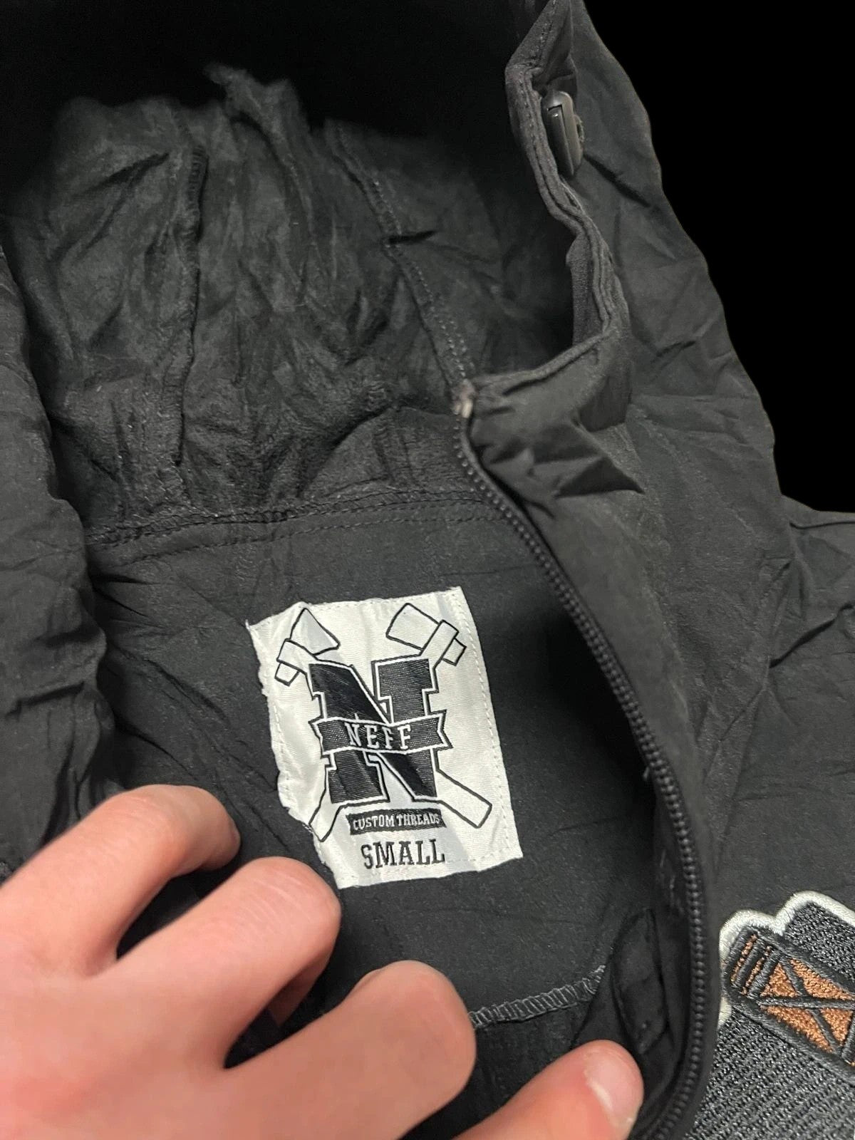 Premier Vintage black and grey varsity hooded jacket with Neff logo patch and contrasting sleeves.