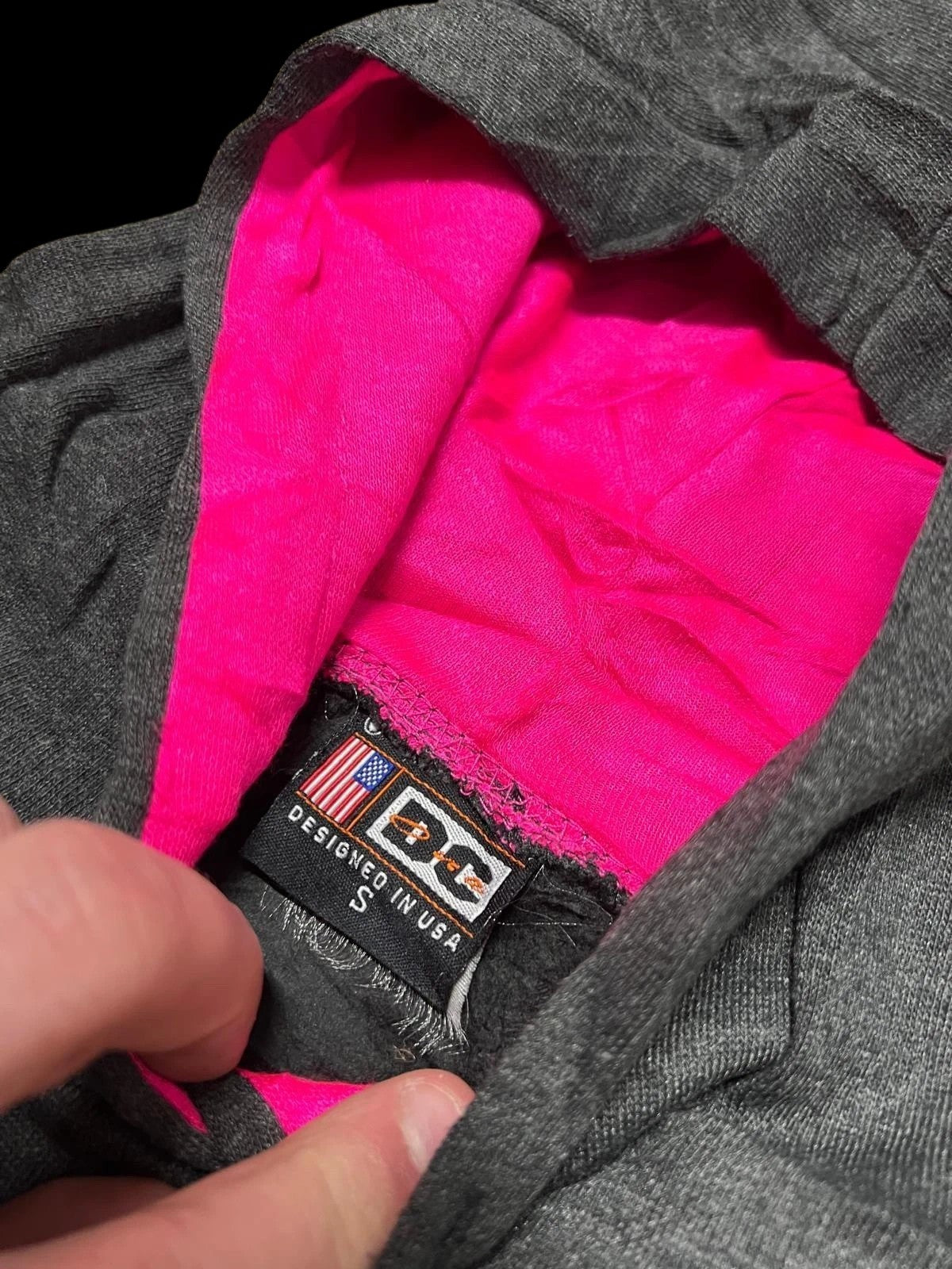 Premier Vintage dark grey hoodie with bright pink hood lining and "DC" logo tag. Size S.