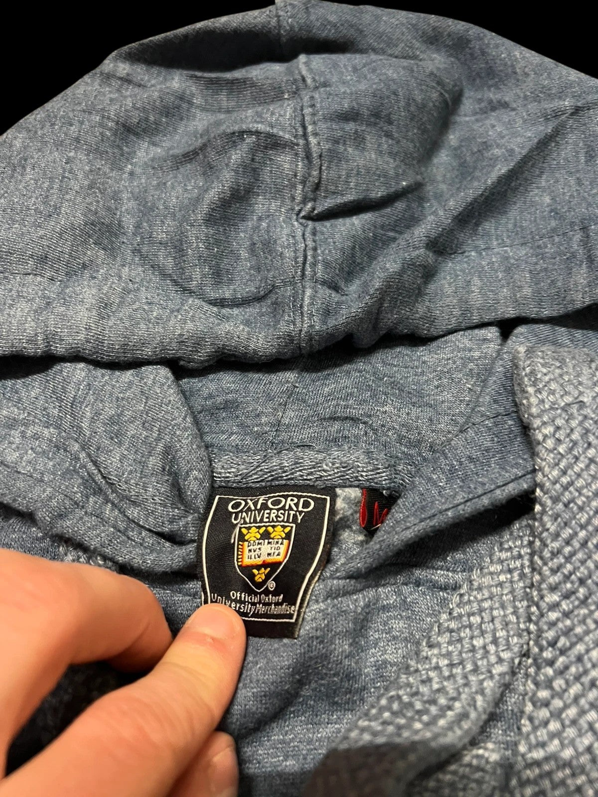 Premier Vintage heathered blue Oxford University graphic hoodie with crest and lettering. Features hood with drawstrings and kangaroo pocket.